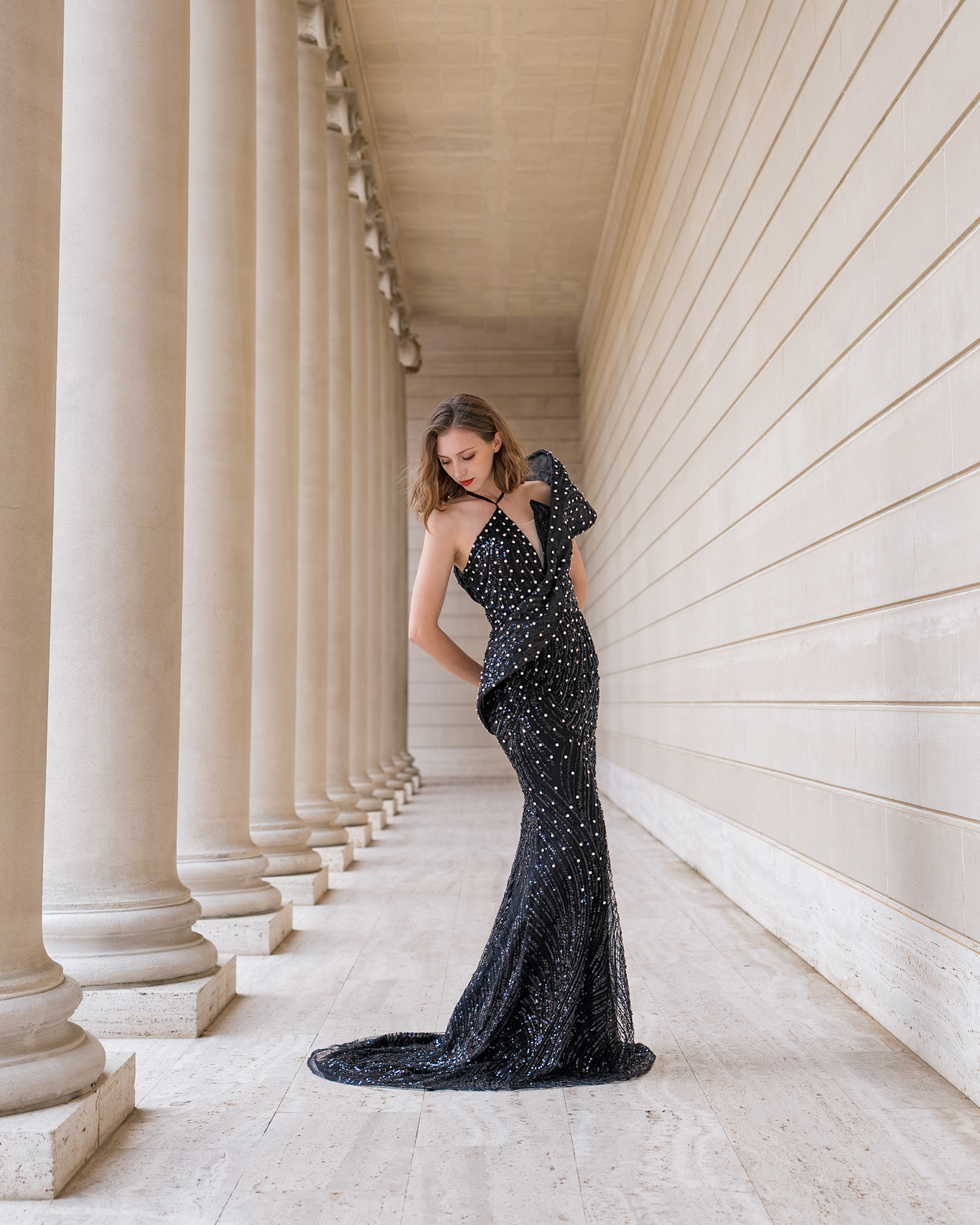 Fashion editorial model in a black gown framed by columns at the Legion of Honor in San Francisco